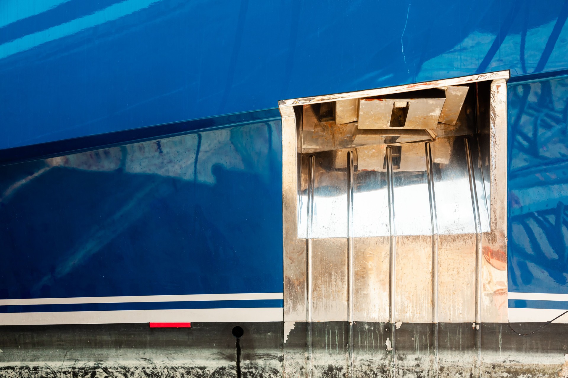 Side view of a luxury yacht with an anchor in the anchor hawse.